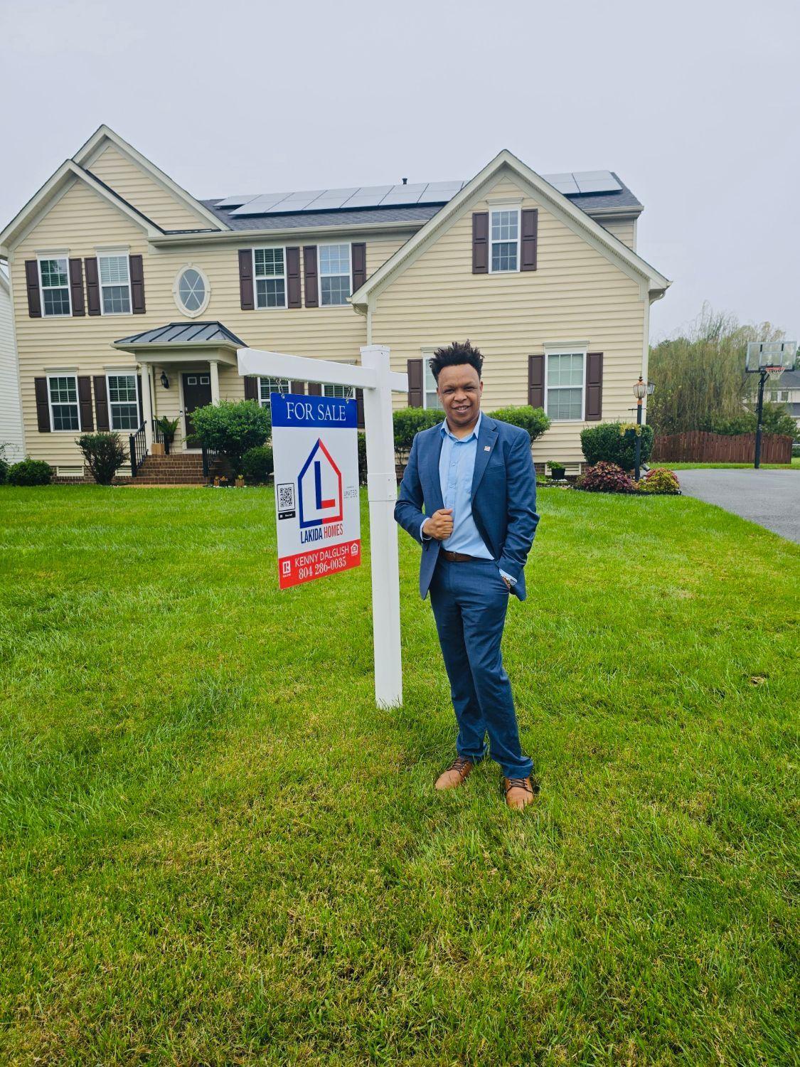 Kenny Dalglish beside the Lakida Homes For Sale sign at 3536 Hunton Ridge Dr